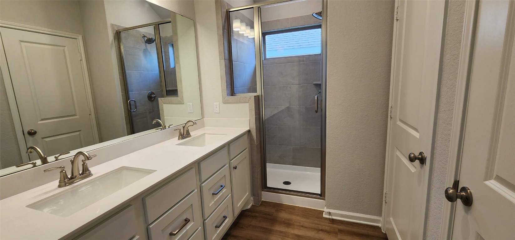 212 Los Olives Lane Georgetown, TX 78628 - Photo 23 of 35 a bathroom with a double vanity sink mirror and shower