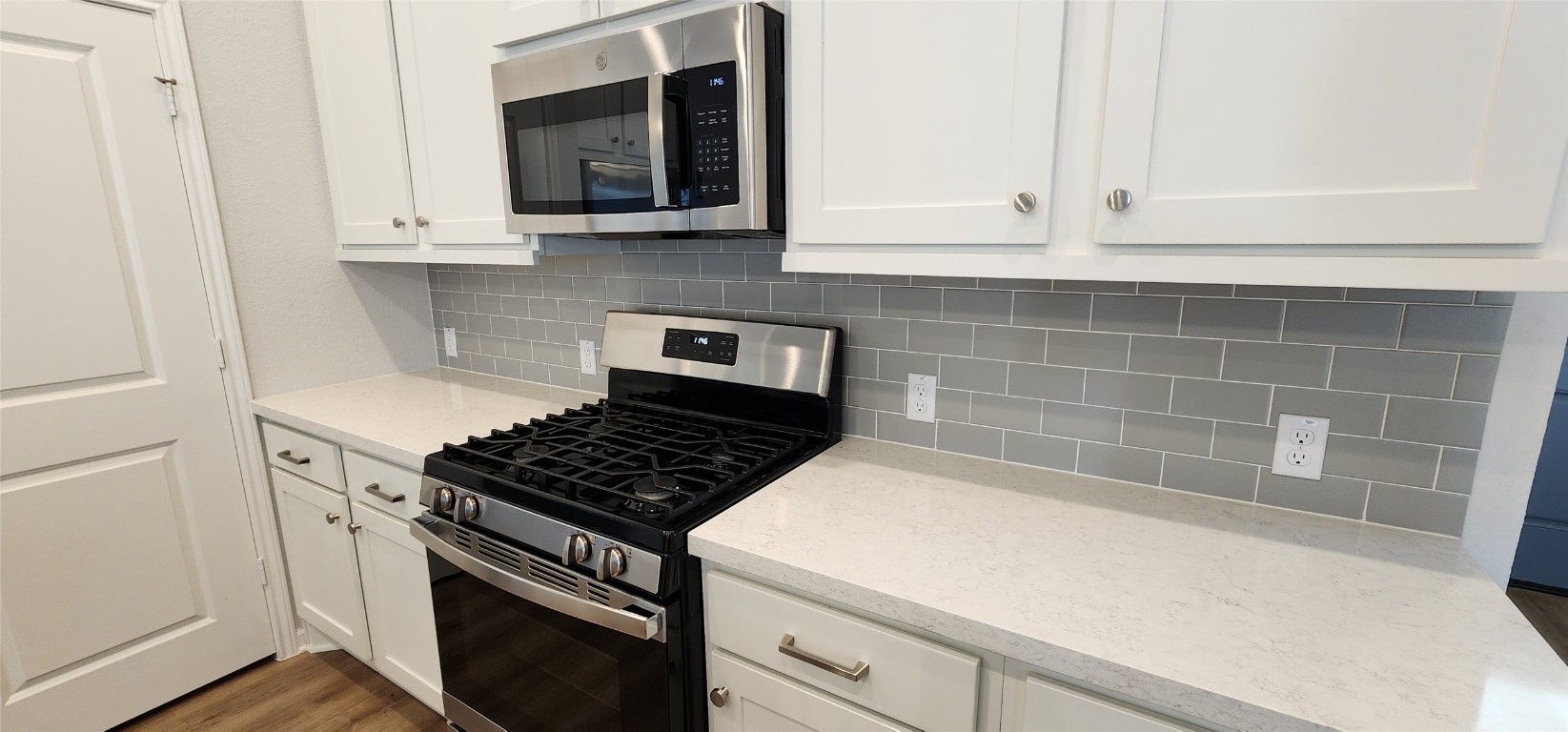 212 Los Olives Lane Georgetown, TX 78628 - Photo 9 of 35 a kitchen with granite countertop white cabinets and stainless steel appliances