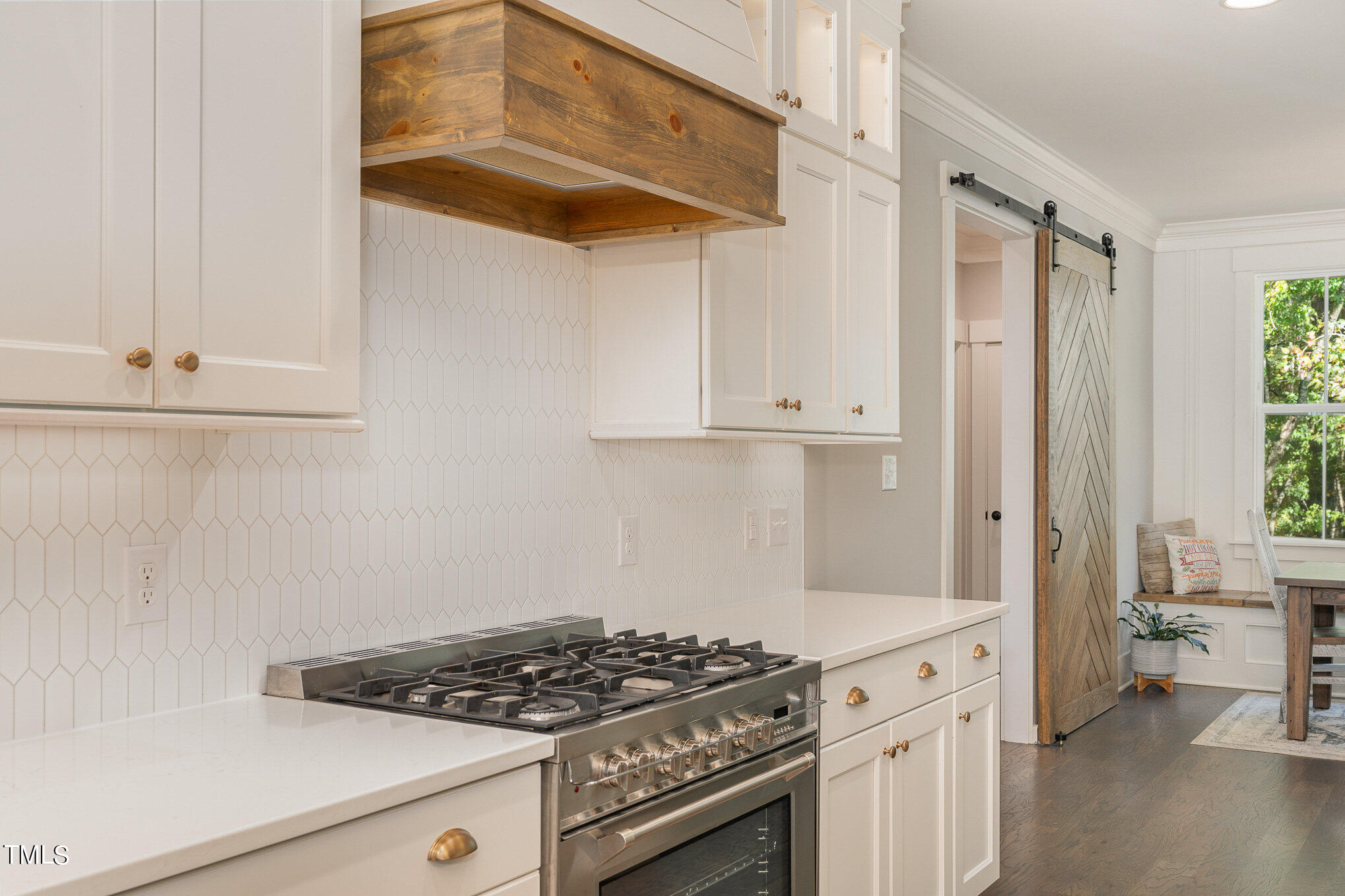 1633 Sweetwater Lane Raleigh, NC 27610 - Photo 18 of 54 a kitchen with white cabinets and white appliances