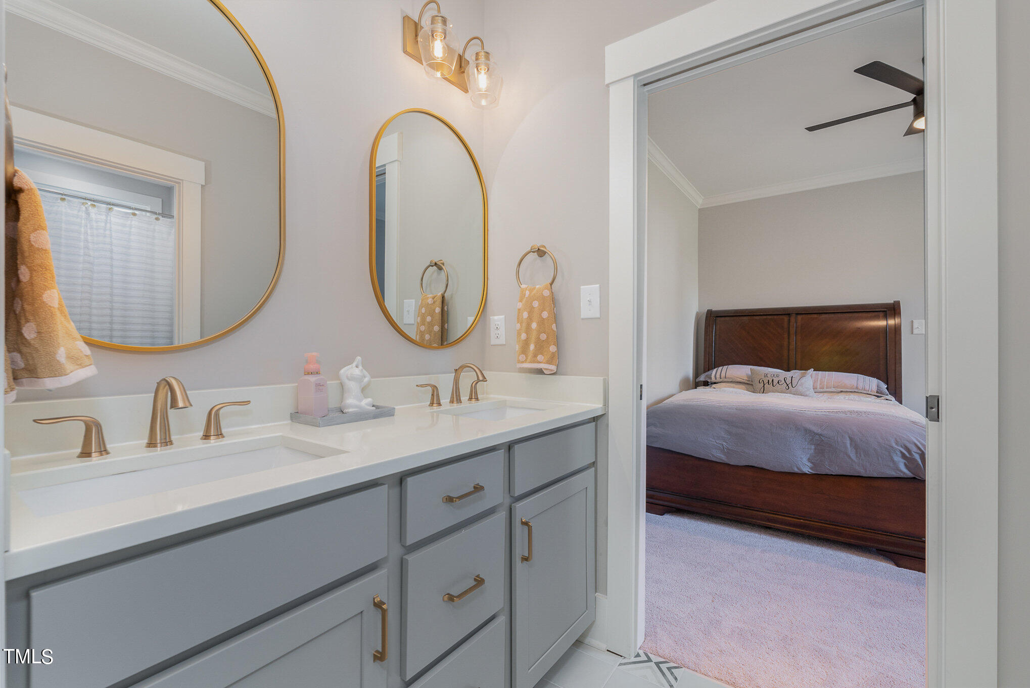1633 Sweetwater Lane Raleigh, NC 27610 - Photo 31 of 54 a en suite bathroom with a double vanity sinks and a mirror