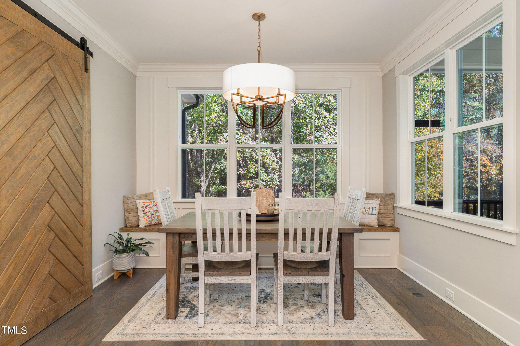1633 Sweetwater Lane Raleigh, NC 27610 - Photo 6 of 54 a dining room with wooden floor a chandelier a wooden table and chairs