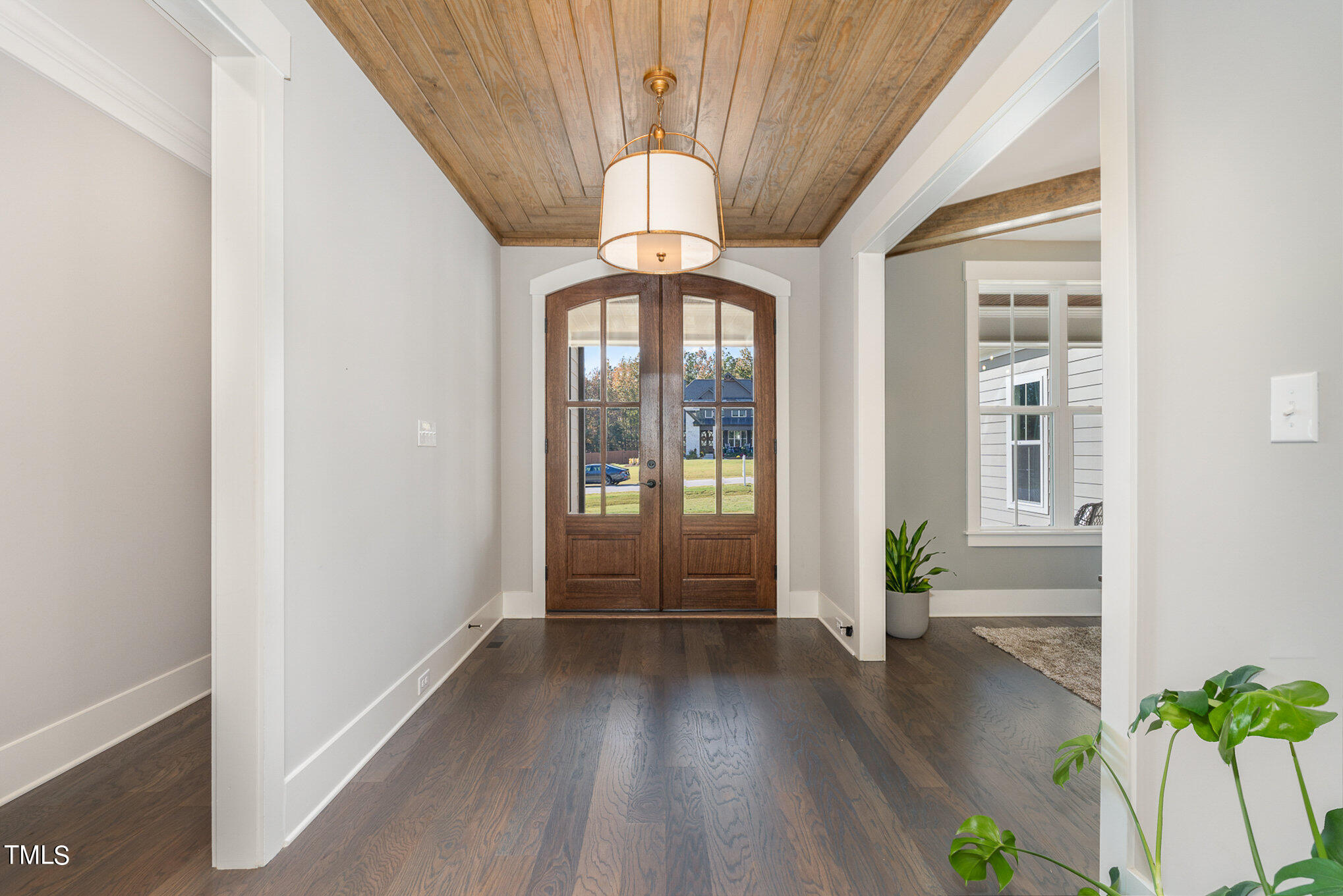 1633 Sweetwater Lane Raleigh, NC 27610 - Photo 8 of 54 a view of a hallway with wooden floor and staircase
