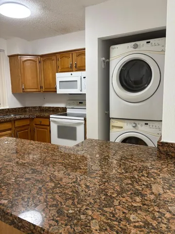 a kitchen with a stove top oven sink and cabinets