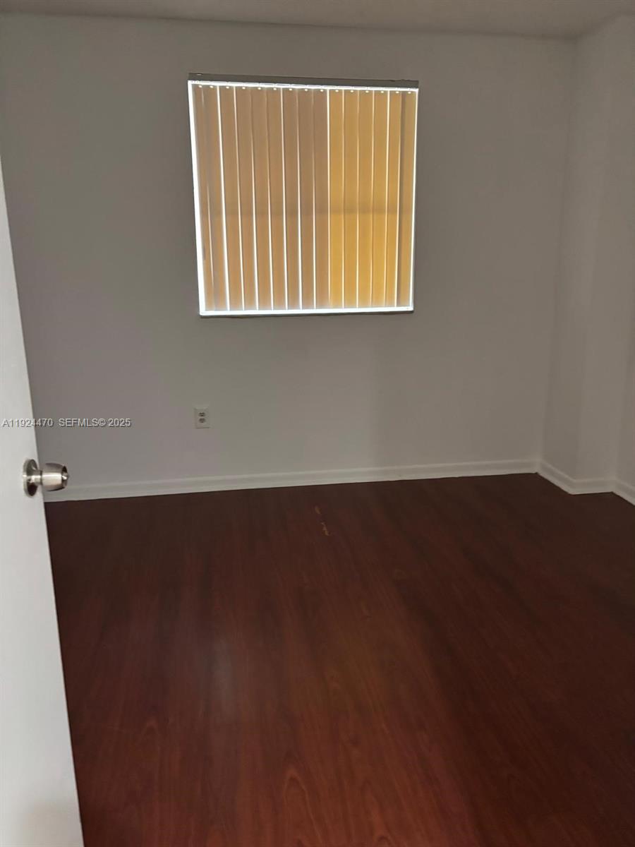 6045 Northwest 186th Street, Unit 123 Hialeah, FL 33015 - Photo 7 of 9 an empty room with a window