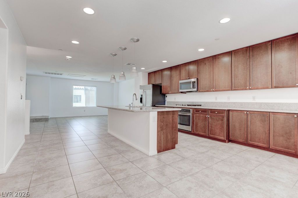 4650 Ranch House Road, Unit 47 North Las Vegas, NV 89031 - Photo 14 of 43 Culinary dreams come alive in this kitchen, featuring an island and stainless steel appliances.
