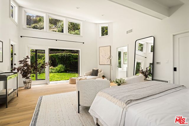 a bedroom with furniture and a large window