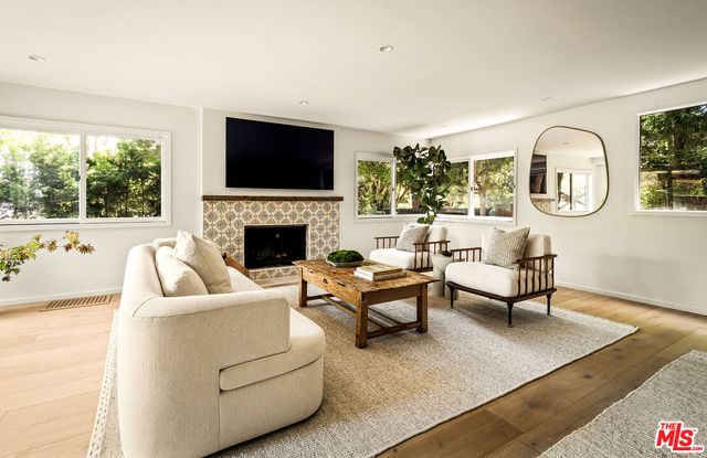 a living room with furniture fireplace and a flat screen tv