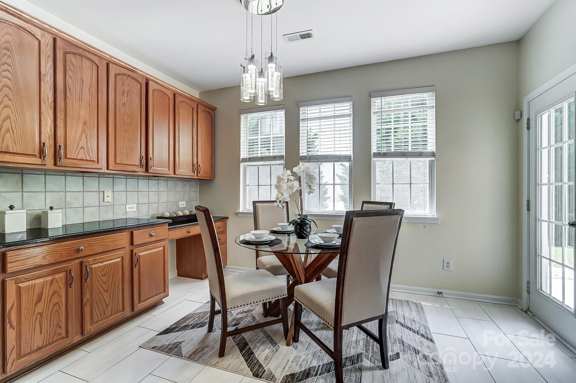 6514 Del Rio Road Charlotte, NC 28277 - Photo 13 of 42 a view of a dining room with furniture window and outside view