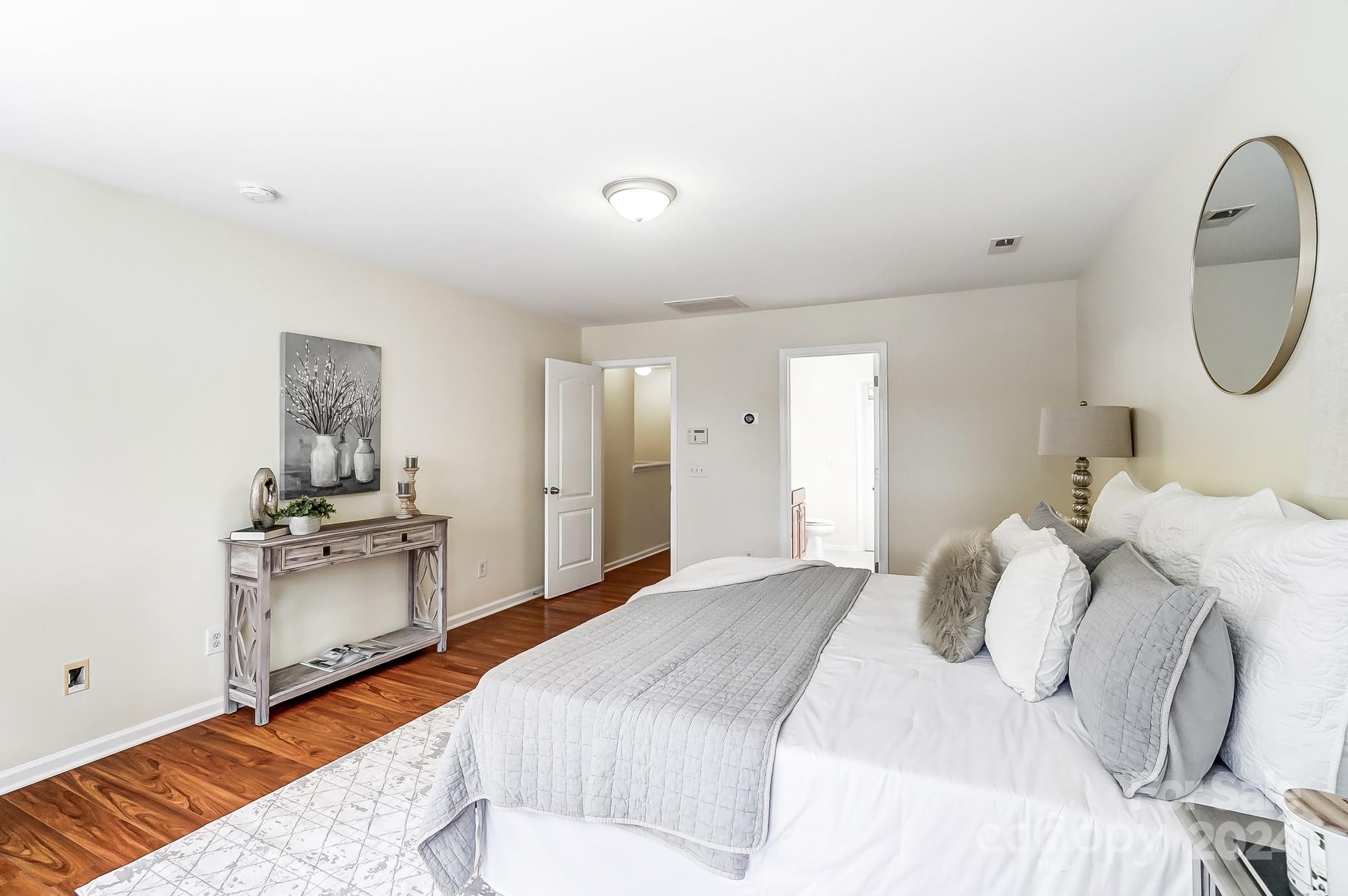 6514 Del Rio Road Charlotte, NC 28277 - Photo 23 of 42 a bedroom with a bed and a chandelier