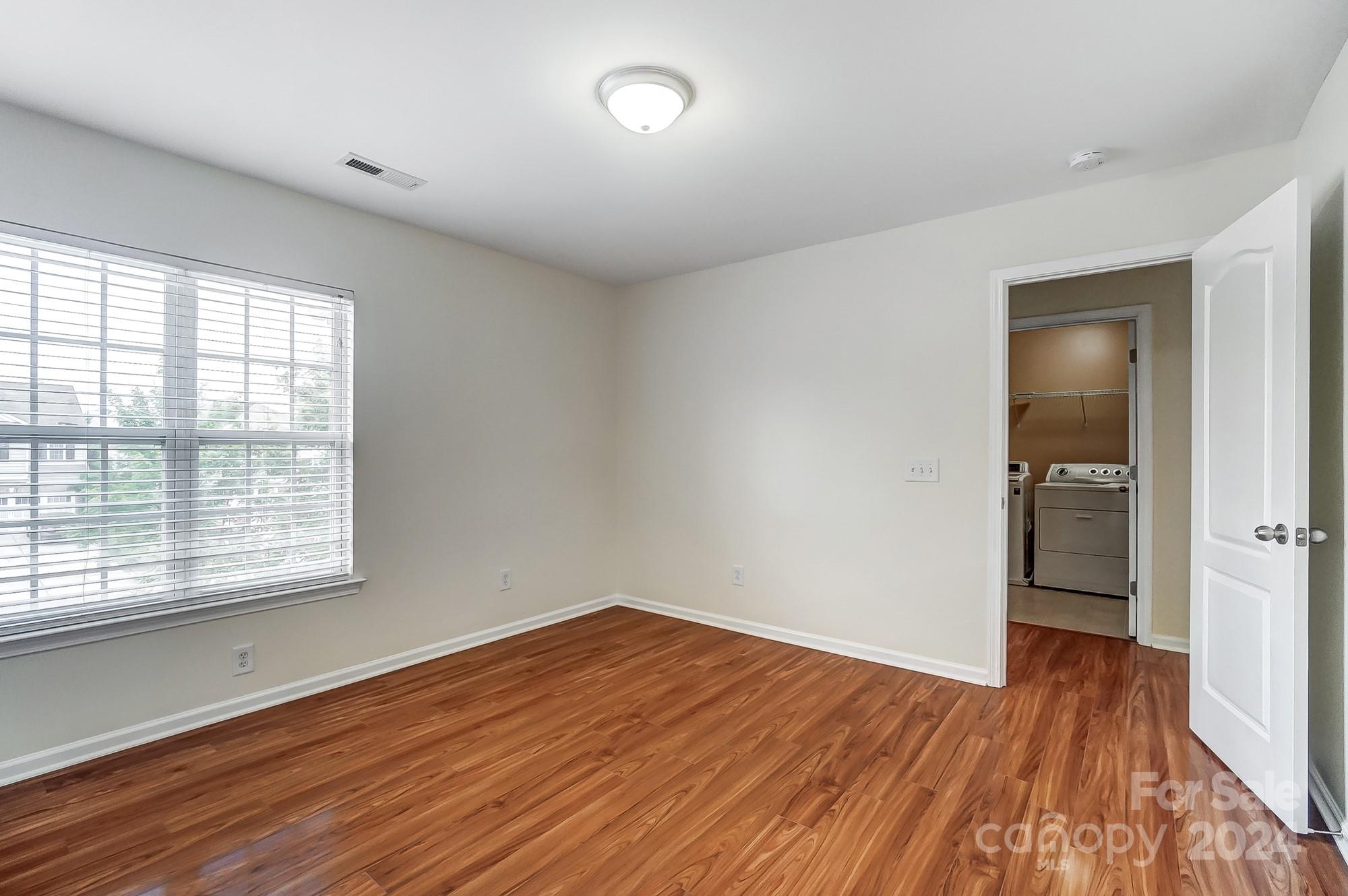 6514 Del Rio Road Charlotte, NC 28277 - Photo 29 of 42 an empty room with wooden floor and windows