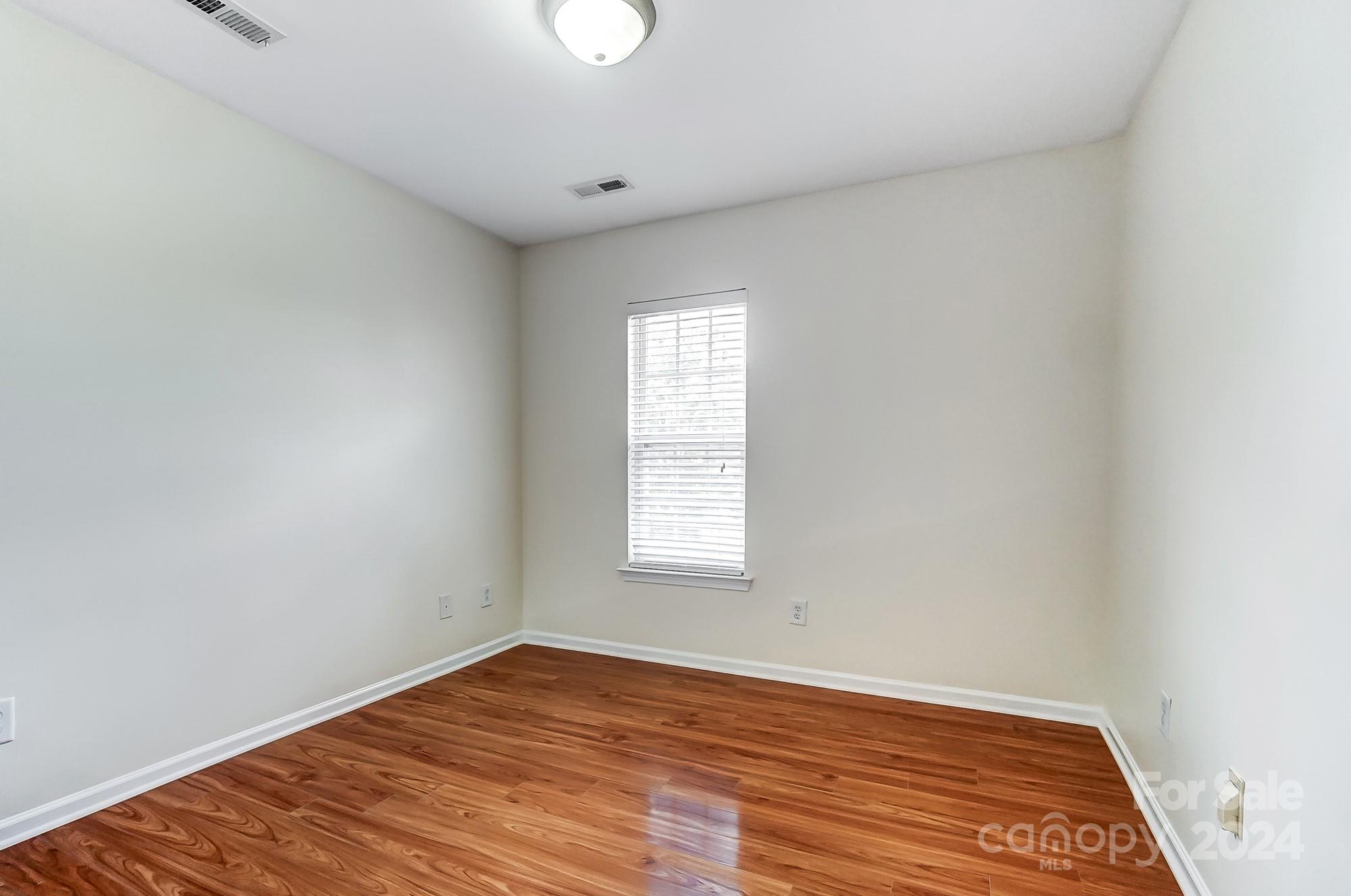 6514 Del Rio Road Charlotte, NC 28277 - Photo 30 of 42 an empty room with wooden floor and windows