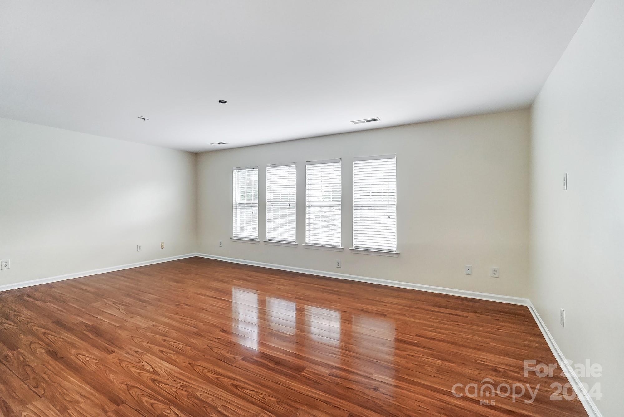 6514 Del Rio Road Charlotte, NC 28277 - Photo 32 of 42 a view of an empty room with wooden floor and a window