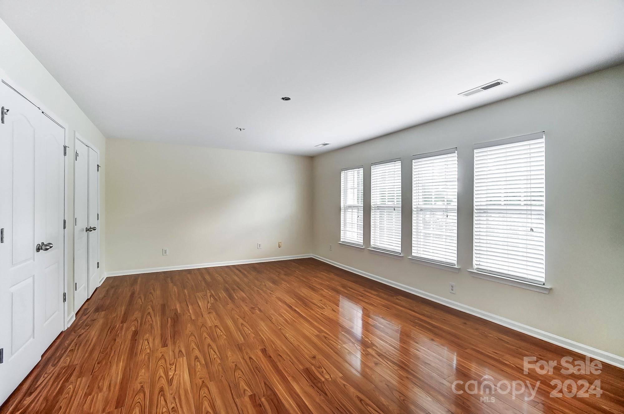 6514 Del Rio Road Charlotte, NC 28277 - Photo 33 of 42 a view of an empty room with wooden floor and a window