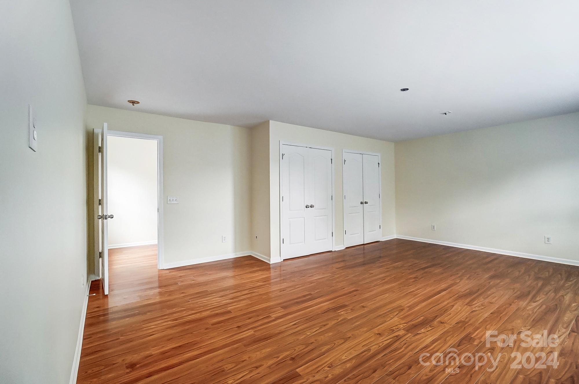 6514 Del Rio Road Charlotte, NC 28277 - Photo 34 of 42 a view of an empty room with wooden floor