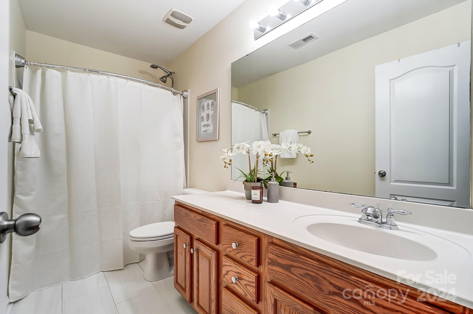 6514 Del Rio Road Charlotte, NC 28277 - Photo 36 of 42 a bathroom with double vanity sink a toilet and a mirror