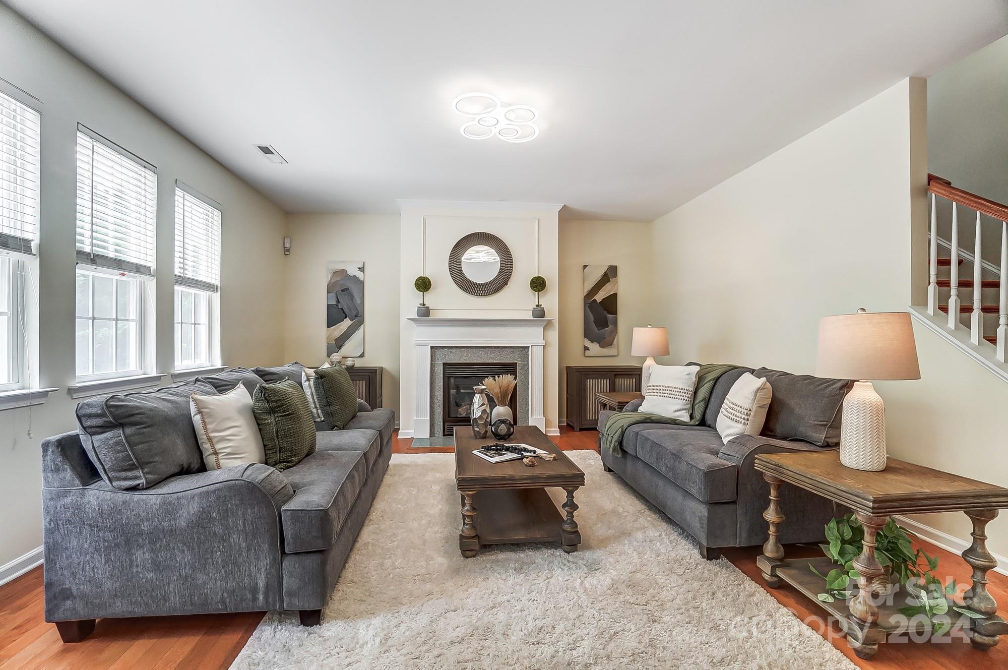6514 Del Rio Road Charlotte, NC 28277 - Photo 6 of 42 a living room with furniture a fireplace and a large window