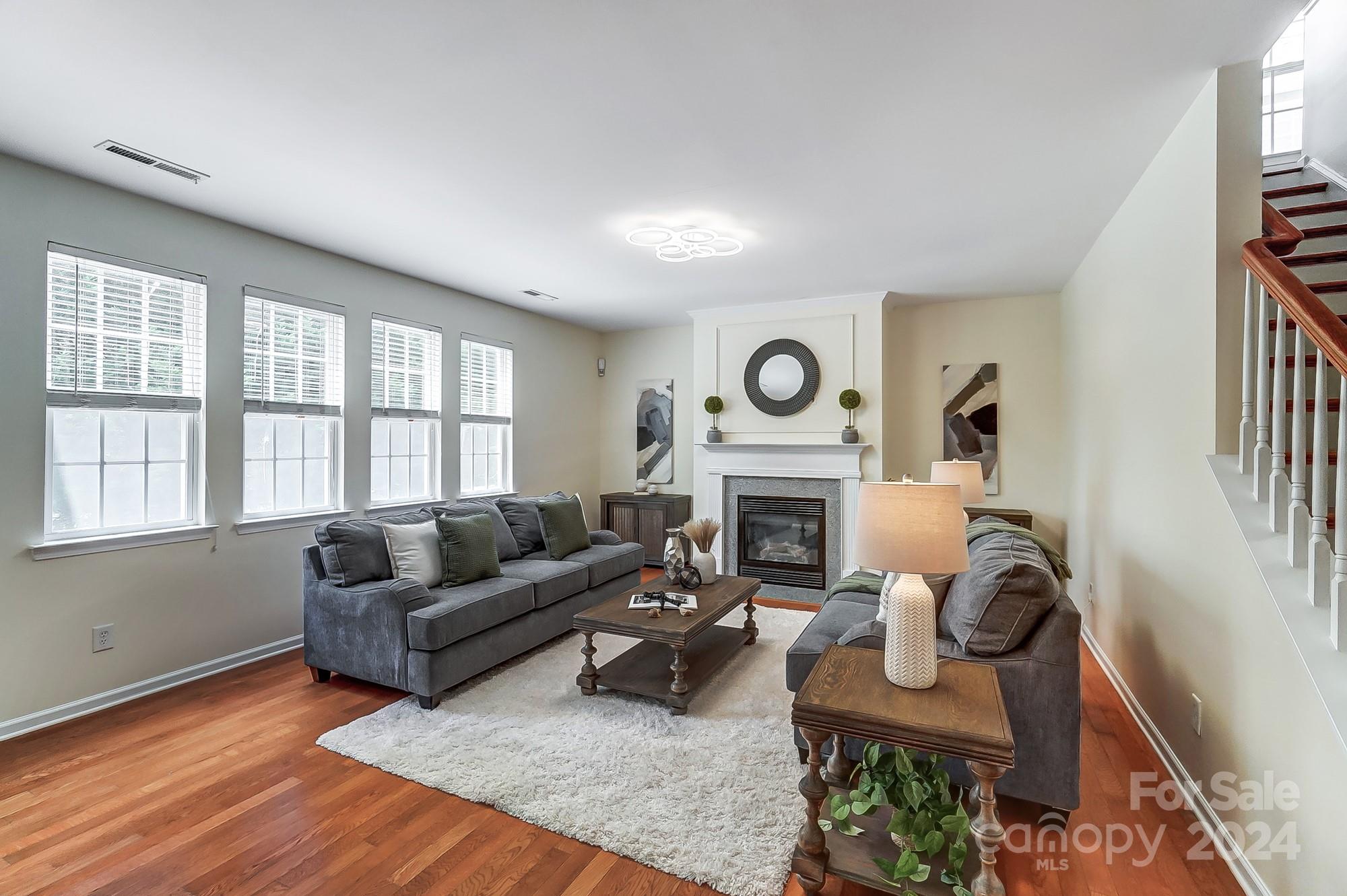 6514 Del Rio Road Charlotte, NC 28277 - Photo 7 of 42 a living room with furniture a fireplace and a large window