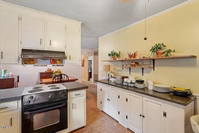 a kitchen with stainless steel appliances a stove a sink and cabinets