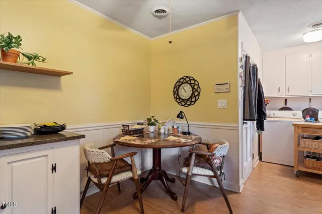 a view of a dining room with furniture and a table