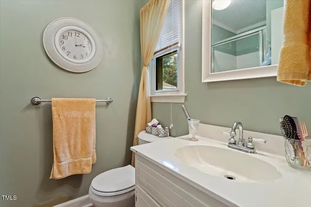 a bathroom with a toilet a sink and a mirror