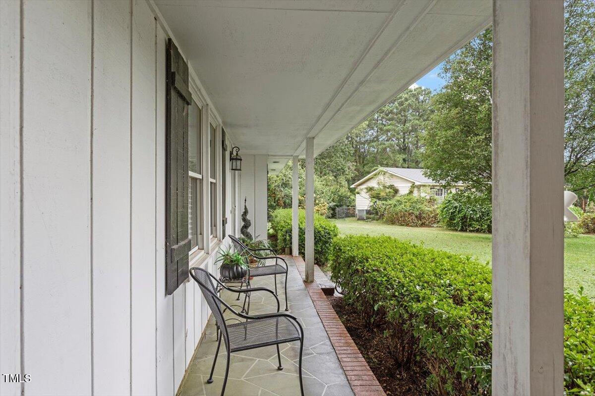 613 Devon Place Zebulon, NC 27597 - Photo 2 of 25 a view of a porch with chairs and backyard