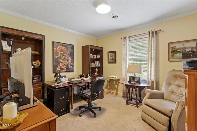 a view of a livingroom with workspace and a couch