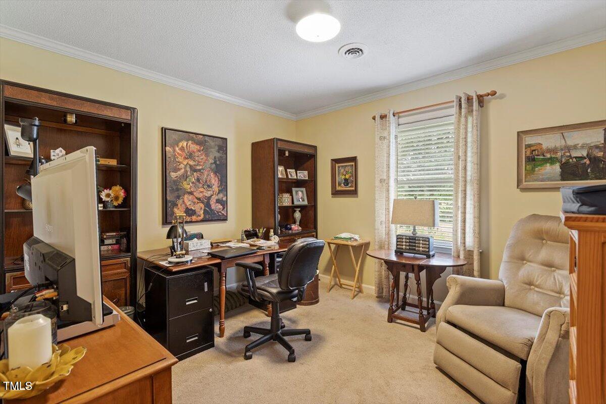 613 Devon Place Zebulon, NC 27597 - Photo 21 of 25 a view of a livingroom with workspace and a couch