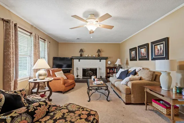 a living room with furniture fireplace and window