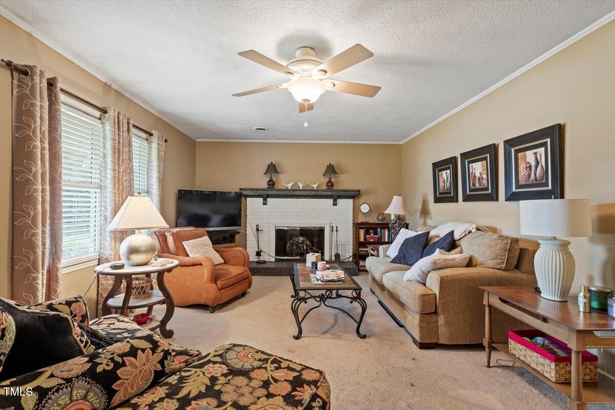 613 Devon Place Zebulon, NC 27597 - Photo 6 of 25 a living room with furniture fireplace and window