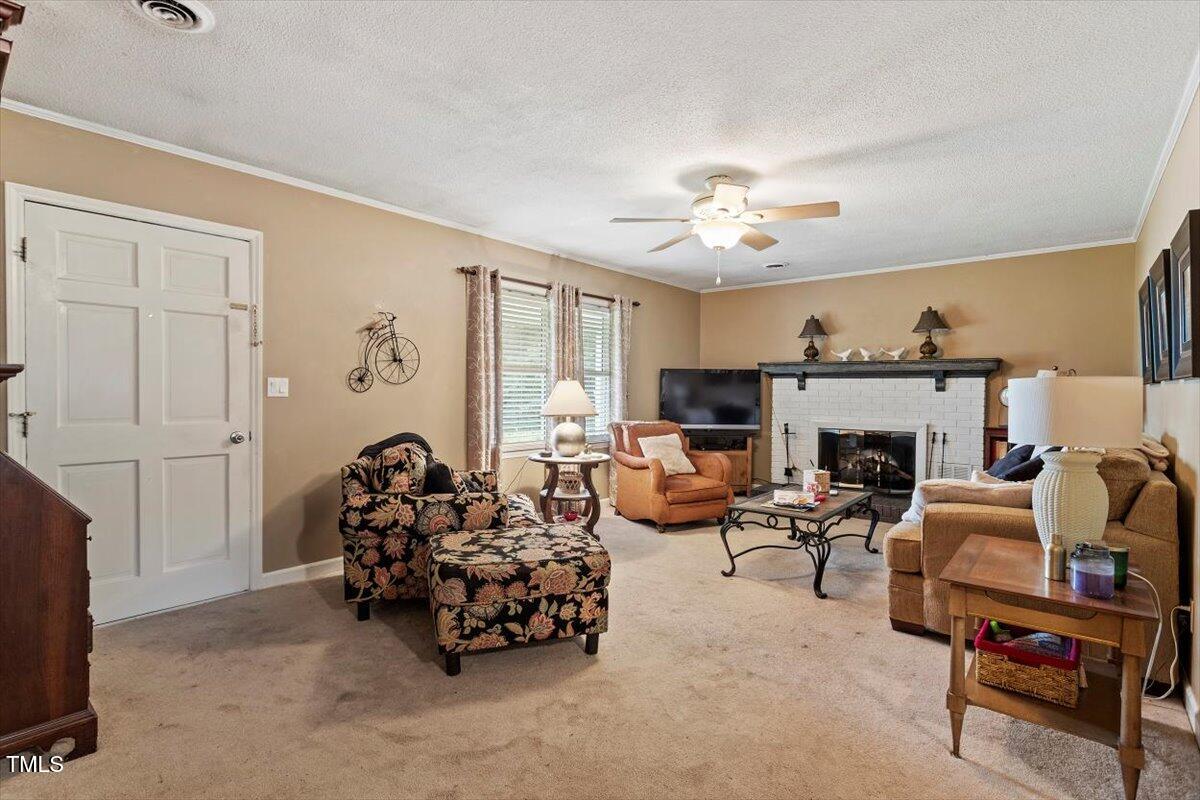 613 Devon Place Zebulon, NC 27597 - Photo 7 of 25 a living room with furniture and a fireplace