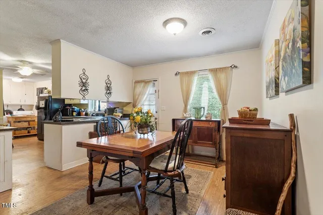 a dining room with furniture and window