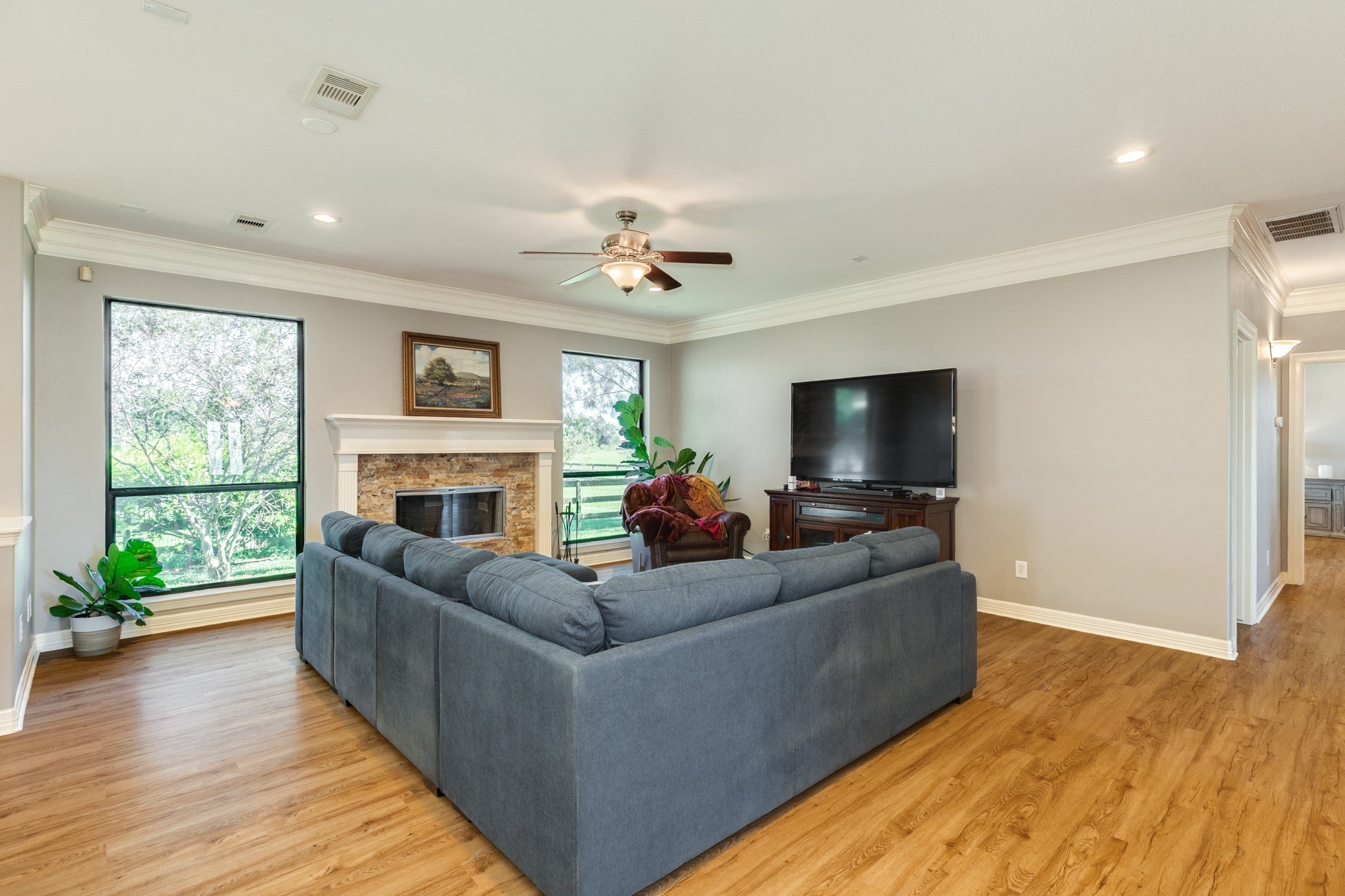 16211 Tankersley Drive Rosharon, TX 77583 - Photo 16 of 46 a living room with furniture a flat screen tv and a fireplace