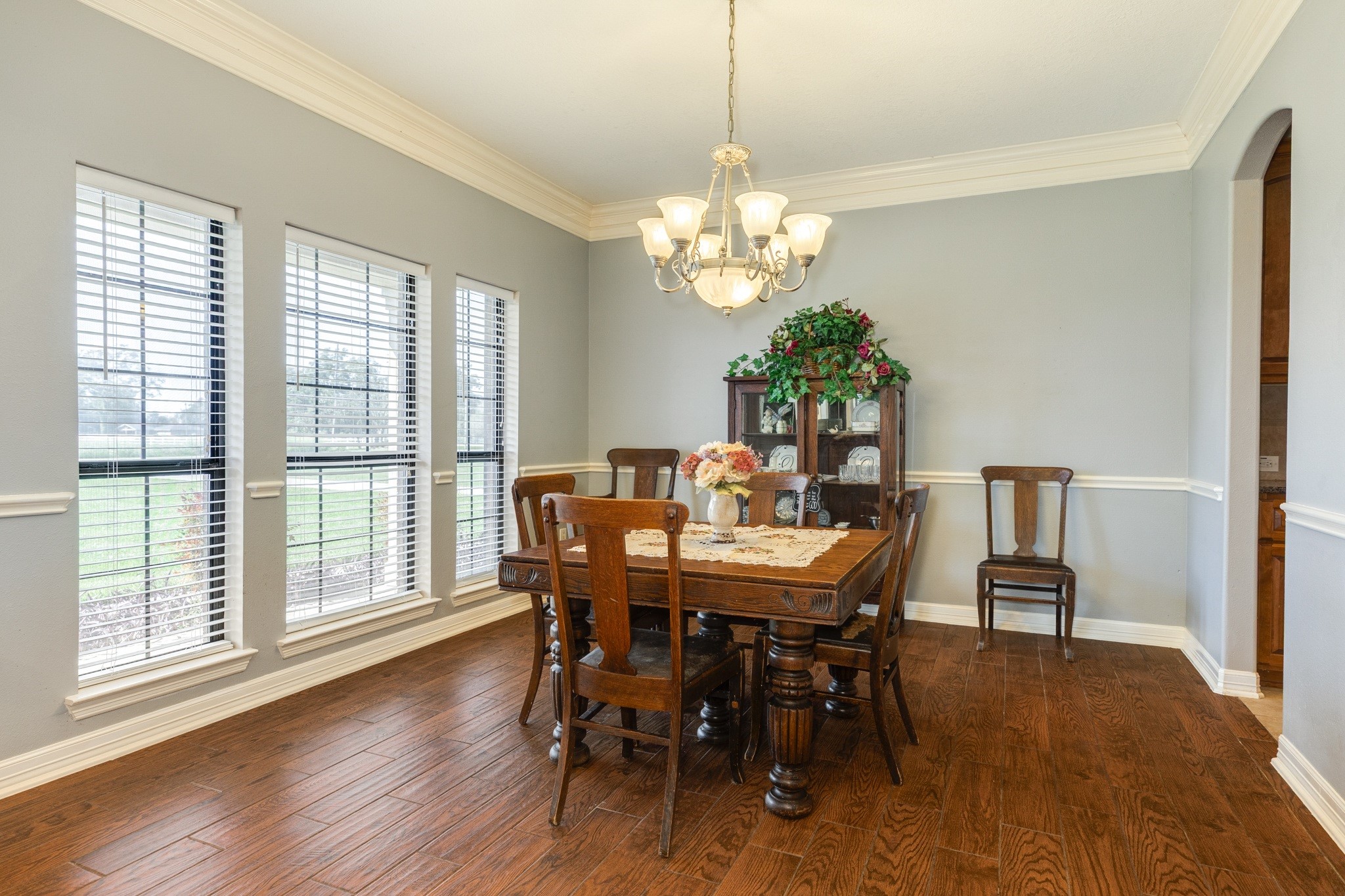 16211 Tankersley Drive Rosharon, TX 77583 - Photo 19 of 46 a view of a dining room with furniture a chandelier and wooden floor