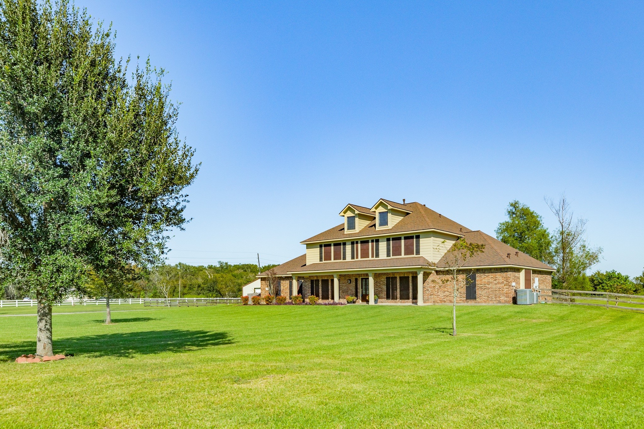 16211 Tankersley Drive Rosharon, TX 77583 - Photo 2 of 46 a view of a big house with a big yard and large trees