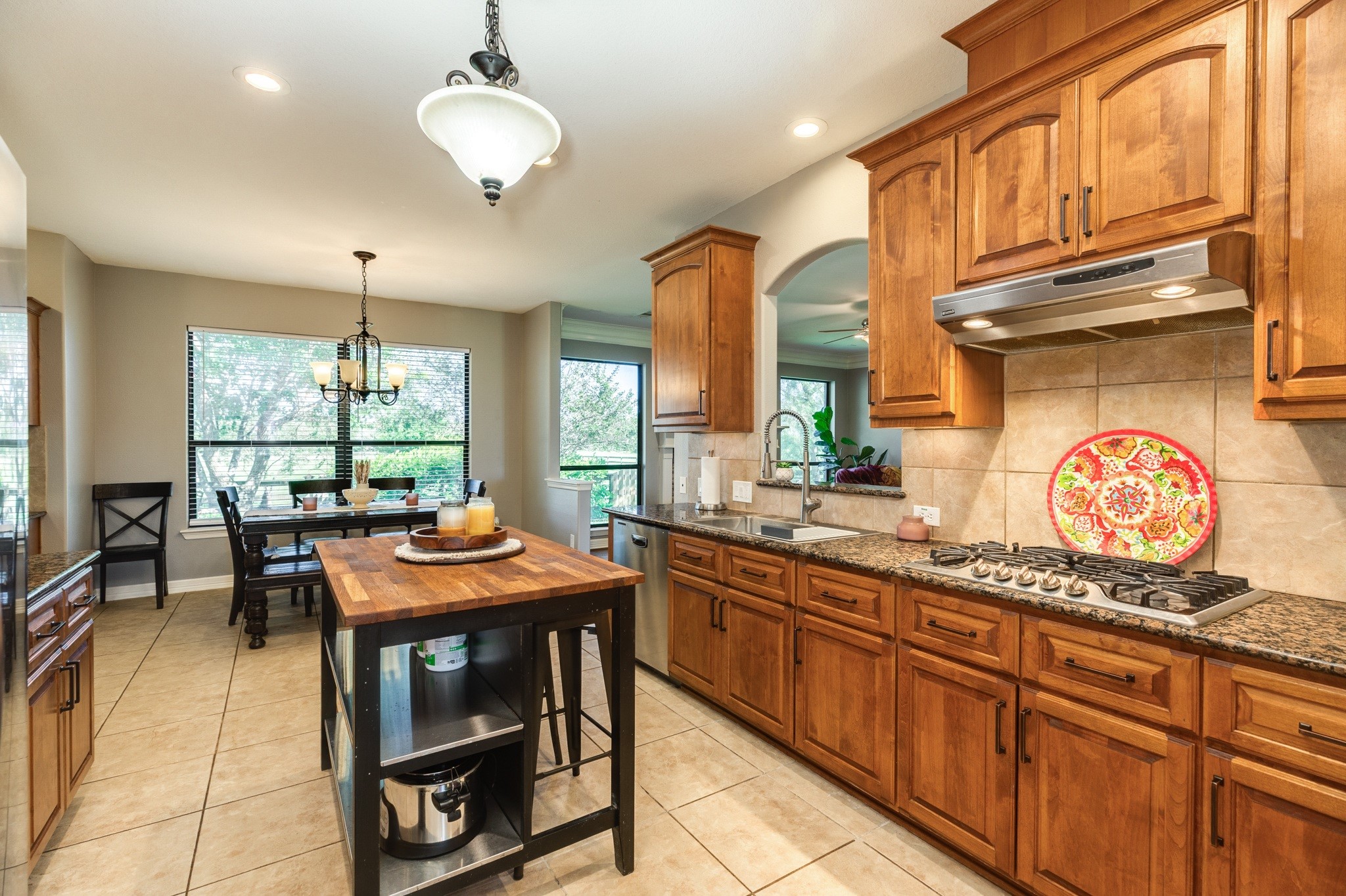 16211 Tankersley Drive Rosharon, TX 77583 - Photo 23 of 46 a kitchen with stainless steel appliances granite countertop a stove a sink and a dining table with granite countertop