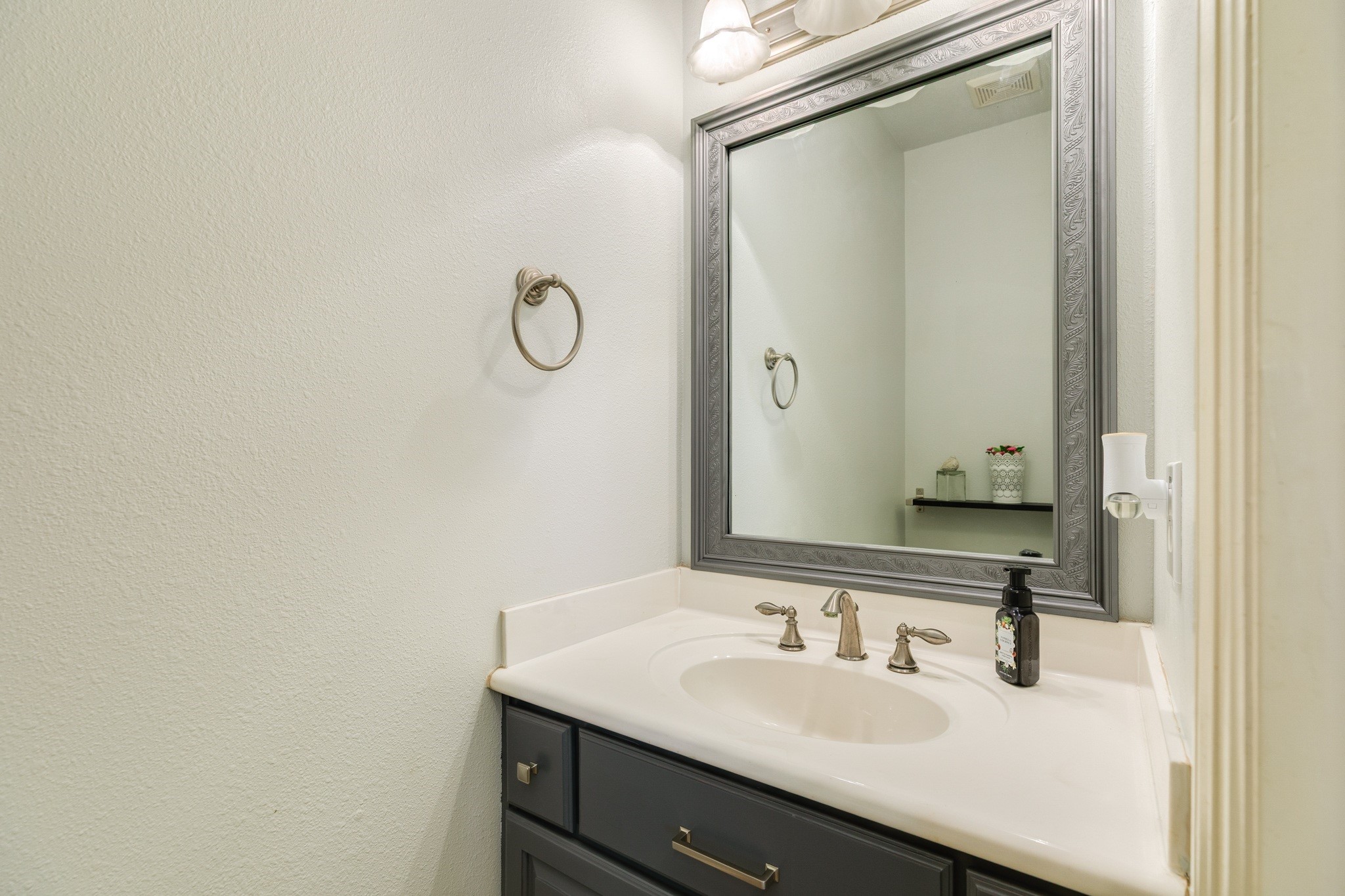 16211 Tankersley Drive Rosharon, TX 77583 - Photo 27 of 46 a bathroom with a sink and a mirror