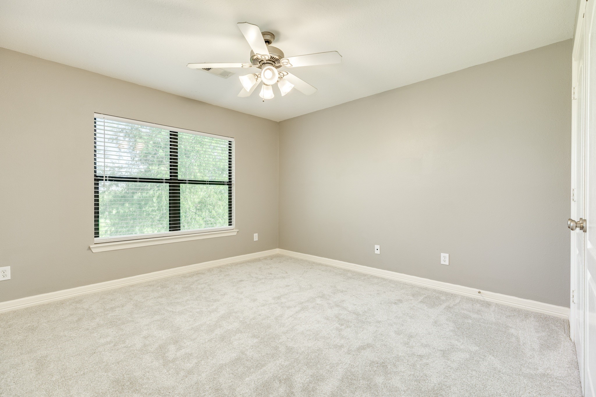 16211 Tankersley Drive Rosharon, TX 77583 - Photo 39 of 46 an empty room with windows and chandelier fan