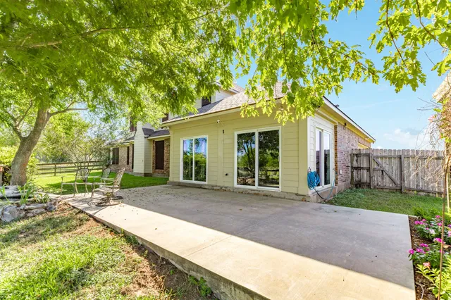 a front view of a house with a yard and potted plants