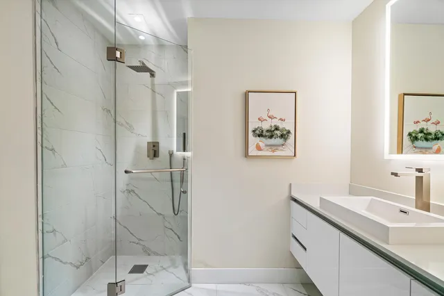a bathroom with a shower sink and mirror