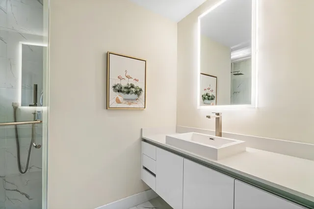 a bathroom with a double vanity sink and a mirror