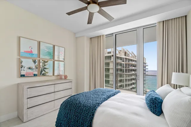 a bedroom with a bed and a large window