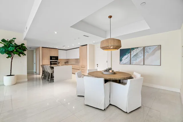 a dining room with furniture and a chandelier
