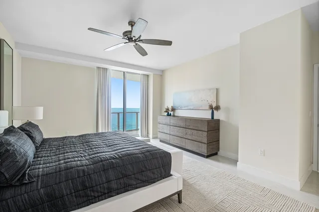 a bedroom with a bed and ceiling fan