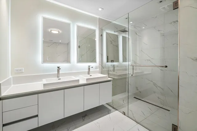 a bathroom with a shower sink and mirror