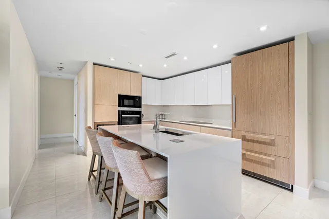 a kitchen with a refrigerator a table and chairs