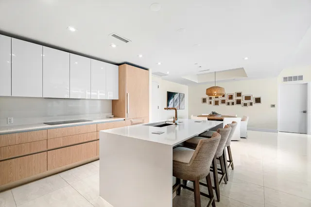 a kitchen with stainless steel appliances kitchen island granite countertop a sink and cabinets