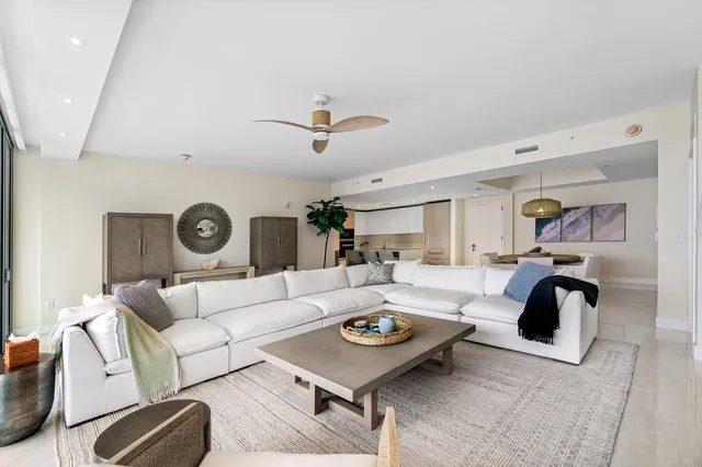 a living room with furniture and a clock