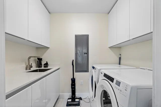 a view of a storage and utility room with washer and dryer