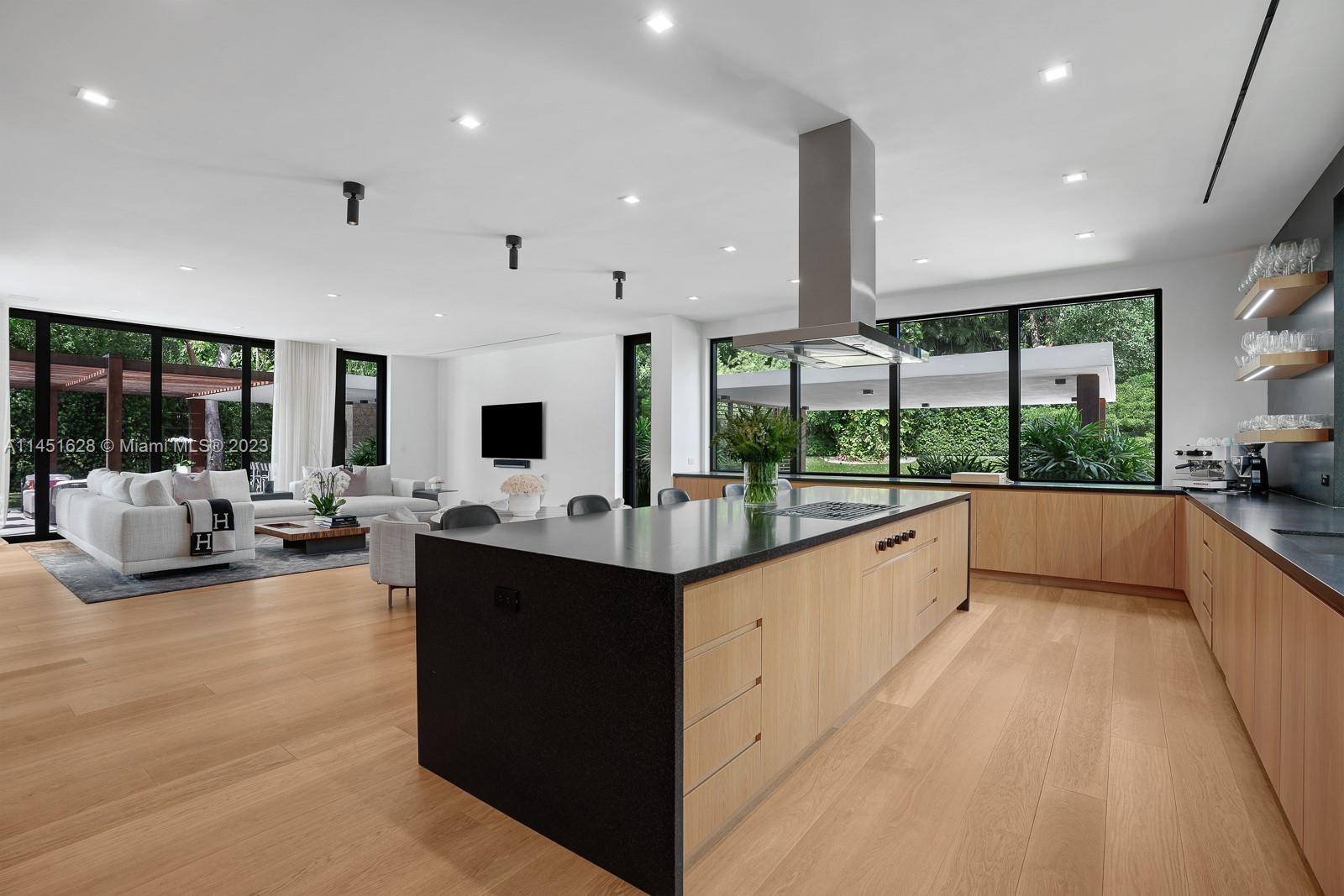 9261 School House Road Coral Gables, FL 33156 - Photo 11 of 65 a view of a kitchen with kitchen island large windows and couches