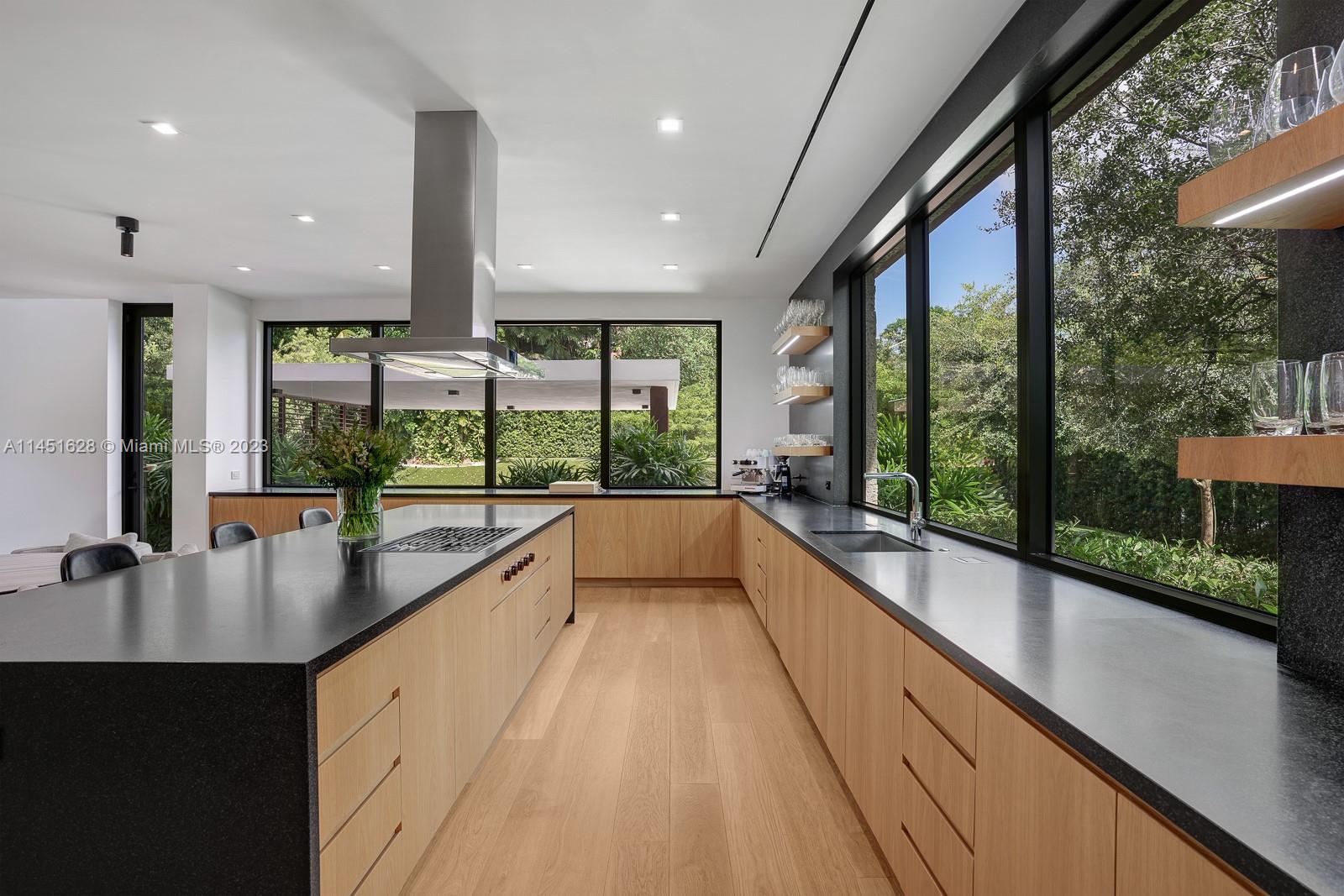 9261 School House Road Coral Gables, FL 33156 - Photo 12 of 65 a view of a kitchen with kitchen island a large window